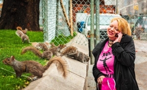 Woman feeding squirrels in Union Square Park, New York City NY027