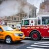 Fire engine and taxi passing on 3rd Avenue, New York City NY029