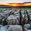 Sunrise over limestone pavement at Malham Lings, Yorkshire Dales, England.