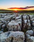 Sunrise over limestone pavement at Malham Lings, Yorkshire Dales, England.