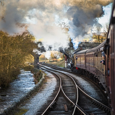 Train Approaching a bridge on the Keighley and Worth Valley Railway, Yorkshire, England