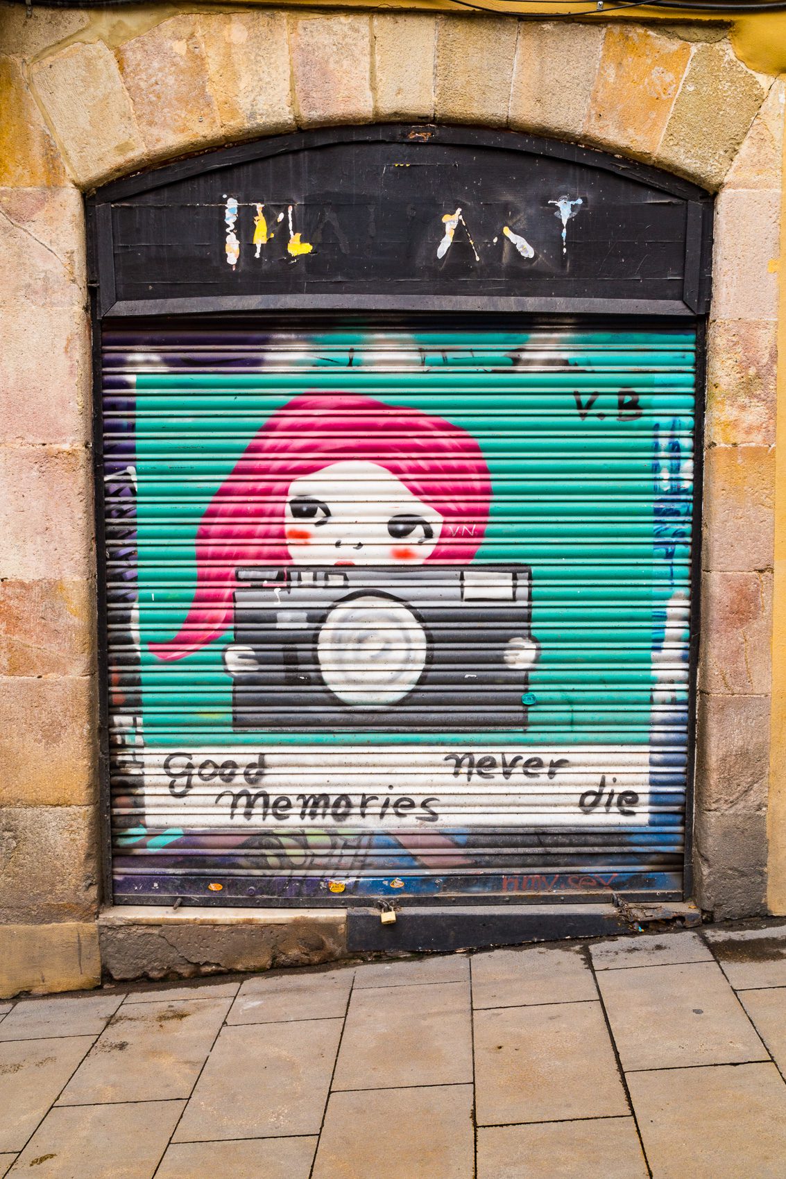 Painted roller door with tag 'Good Memories Never Die' in Barcelona, Spain. BC008