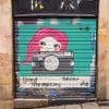 Painted roller door with tag 'Good Memories Never Die' in Barcelona, Spain.