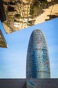 Reflection in mirrored roof of the Encants Vells Flea Market, with the Agbar Tower in the background, Barcelona Spain.