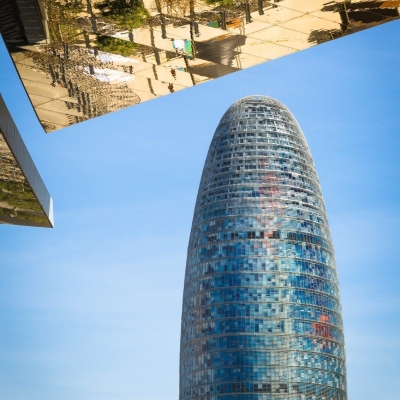 Reflection in mirrored roof of the Encants Vells Flea Market, with the Agbar Tower in the background, Barcelona Spain.