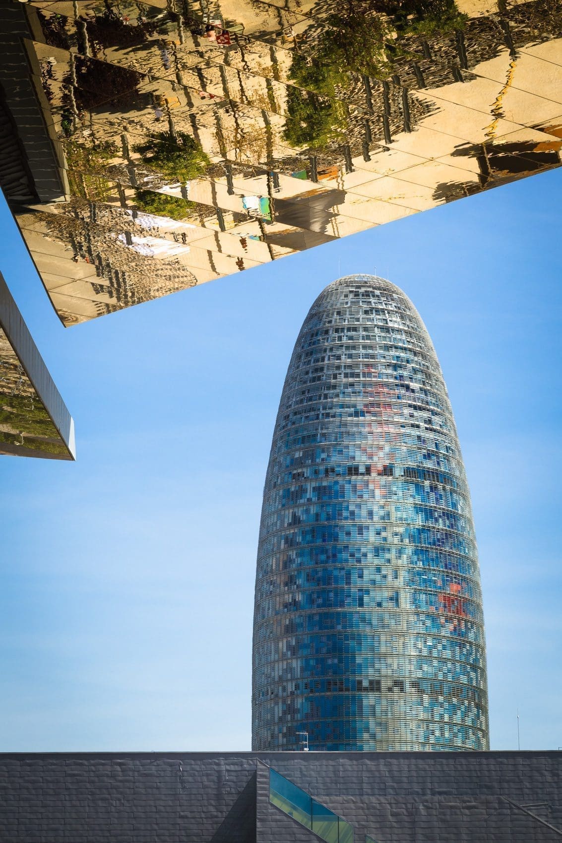 Reflection in mirrored roof of the Encants Vells Flea Market, with the Agbar Tower in the background, Barcelona Spain.