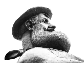 Monochrome (black and white) Desperate Dan statue in Dundee High Street, Scotland. DD016