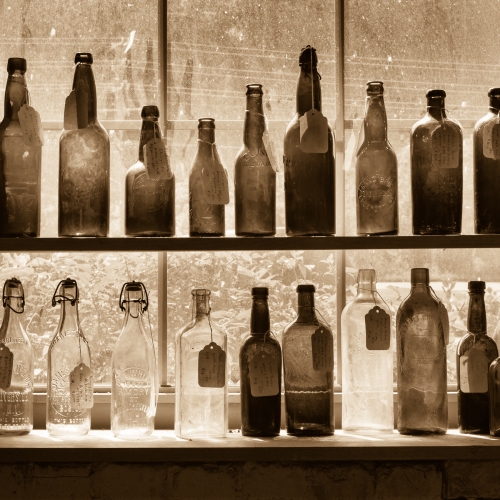 Shelves of antique glass bottles in a vintage store in the River Arts District, Asheville, North Carolina, USA. NC010