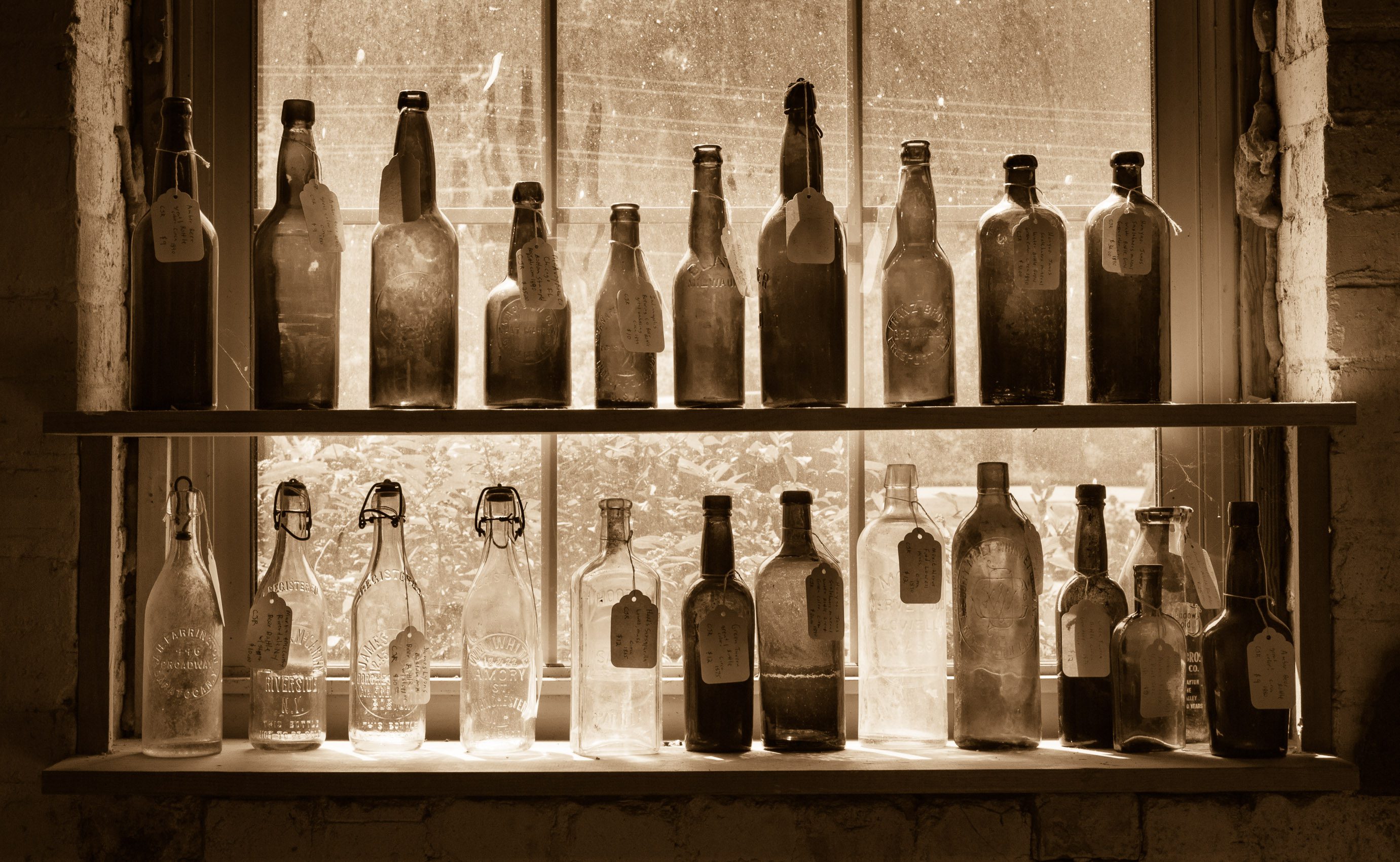 Shelves of antique glass bottles in a vintage store in the River Arts District, Asheville, North Carolina, USA. NC010