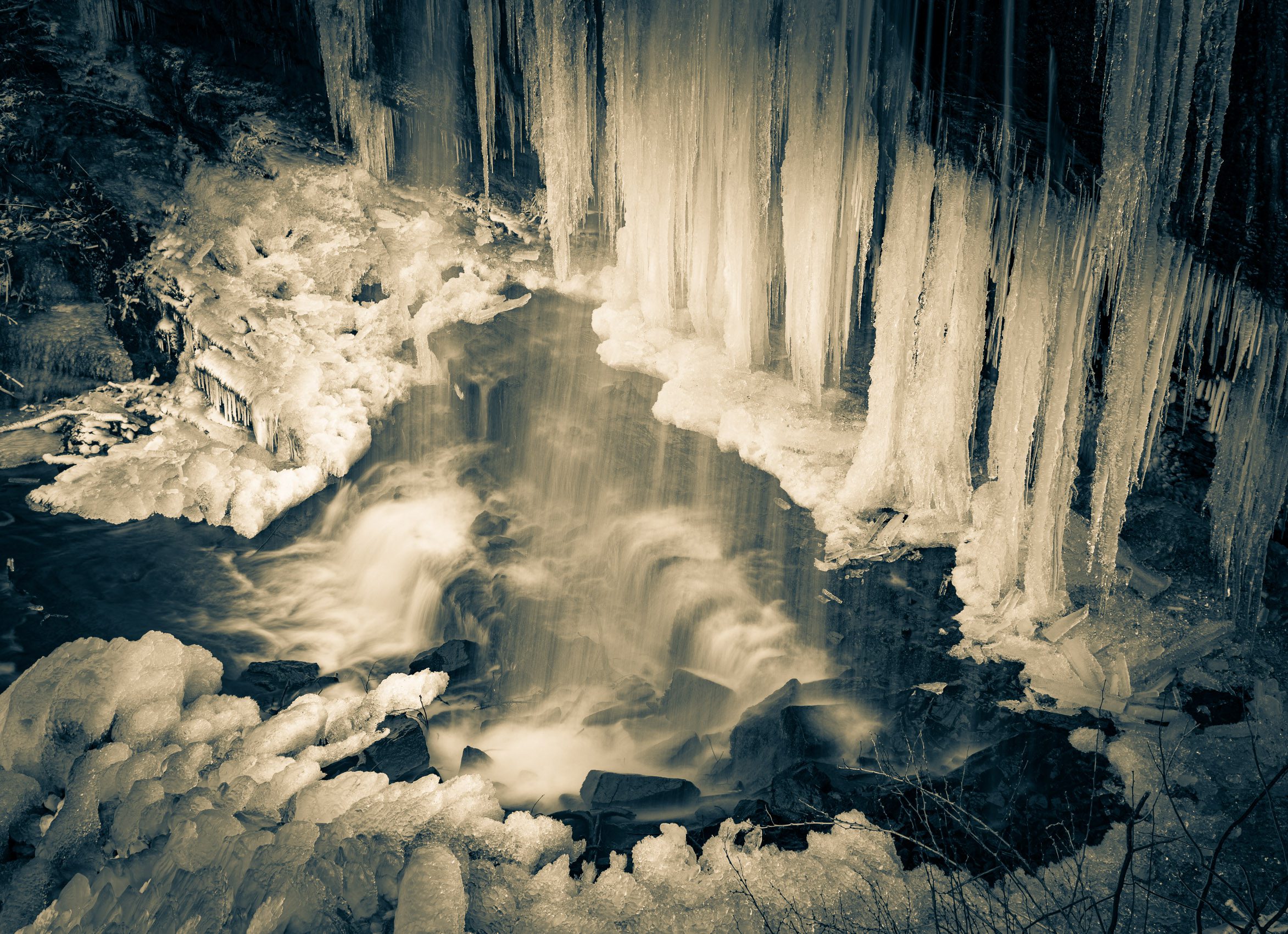 Duotone of a part frozen Grassy Creek Falls, near Little Switzerland, North Carolina, USA. CM017