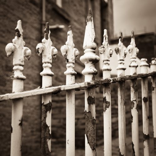 Sepia-toned monochrome image of railings in Stromness, Orkney, Scotland. SM030