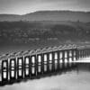 Monochrome image of the Tay Rail Bridge from Dundee, Scotland. DD038