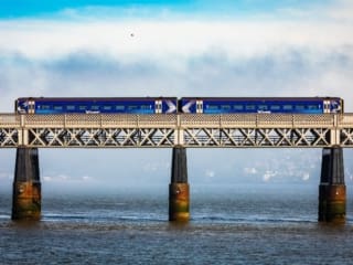 Train crossing the Tay Railway Bridge in fornt of a fog-bank, Dundee, Scotland. DD083