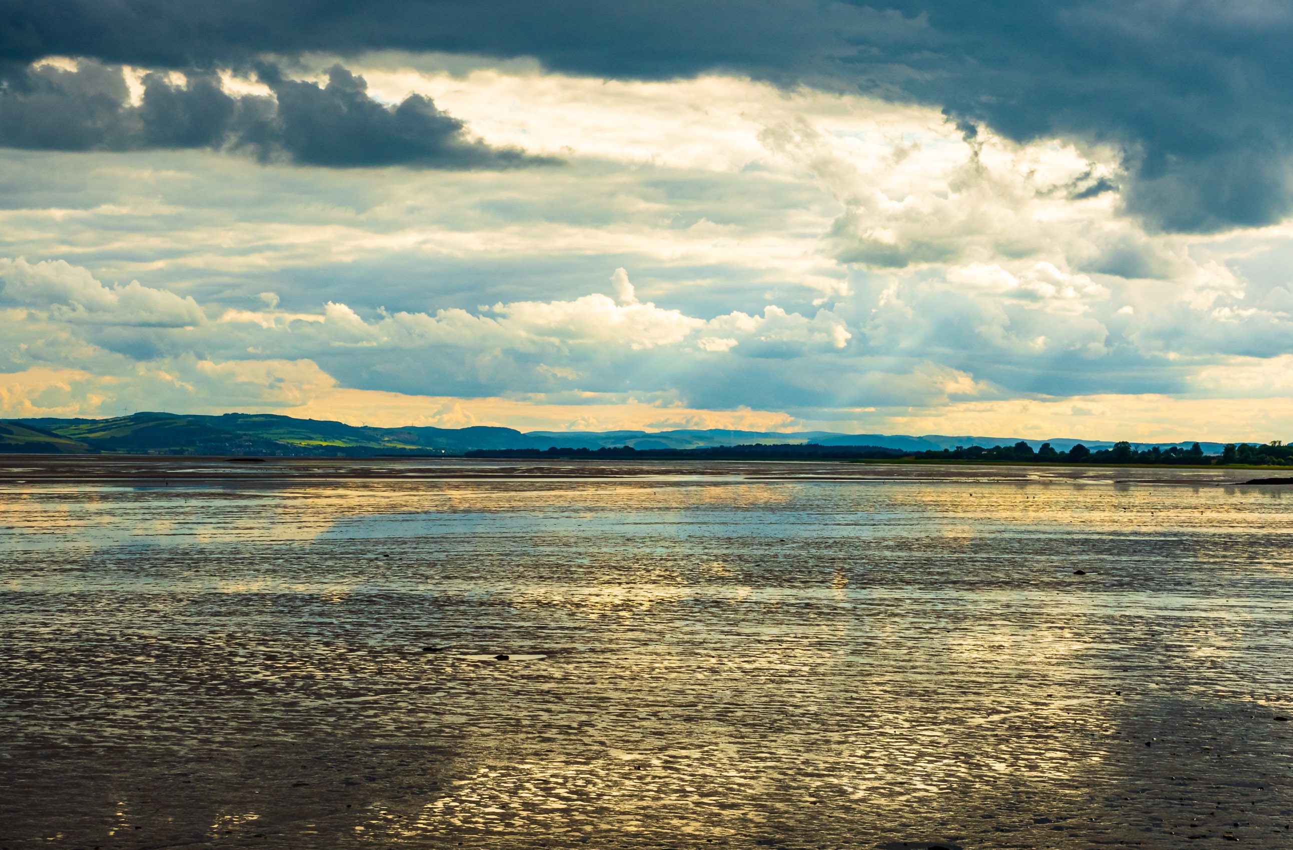 Reflection of a dramatic sky on Tay mudflats at low tide, Invergowrie, Scotland. DD101