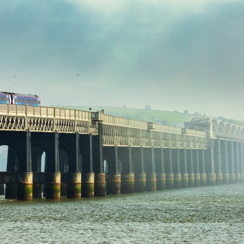 Train passing across the Tay Rail Bridge with a fog bank obscuring the Fife side of the Tay, Scotland. DD084