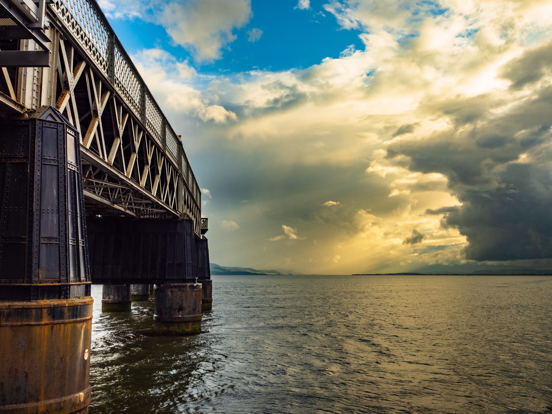 Piers of the Tay Rail Bridge and dramatic cloud formation from Dundee, Scotland. DD098