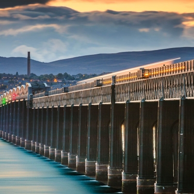 Train crossing the Tay Bridge at dusk, Wormit, Fife, Scotland.