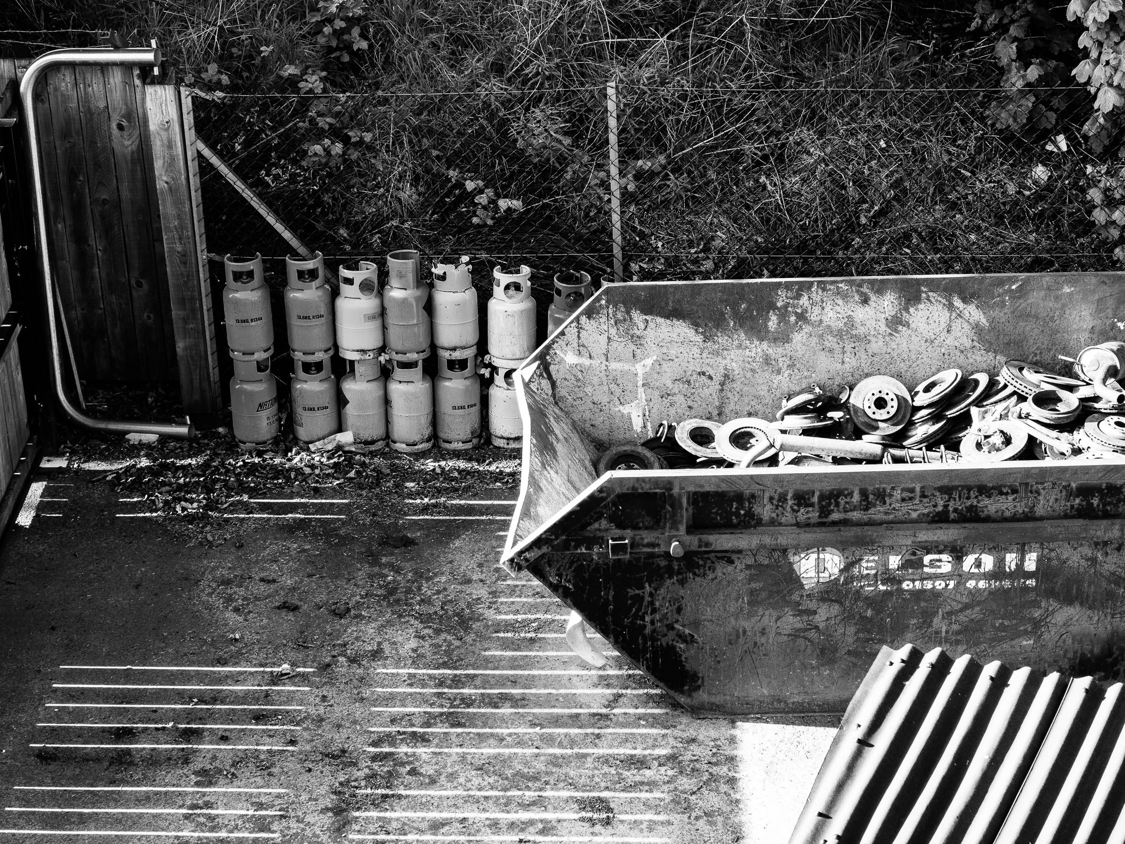 Monochrome (black and white) image of garage waste area, Dundee, Scotland. DD058