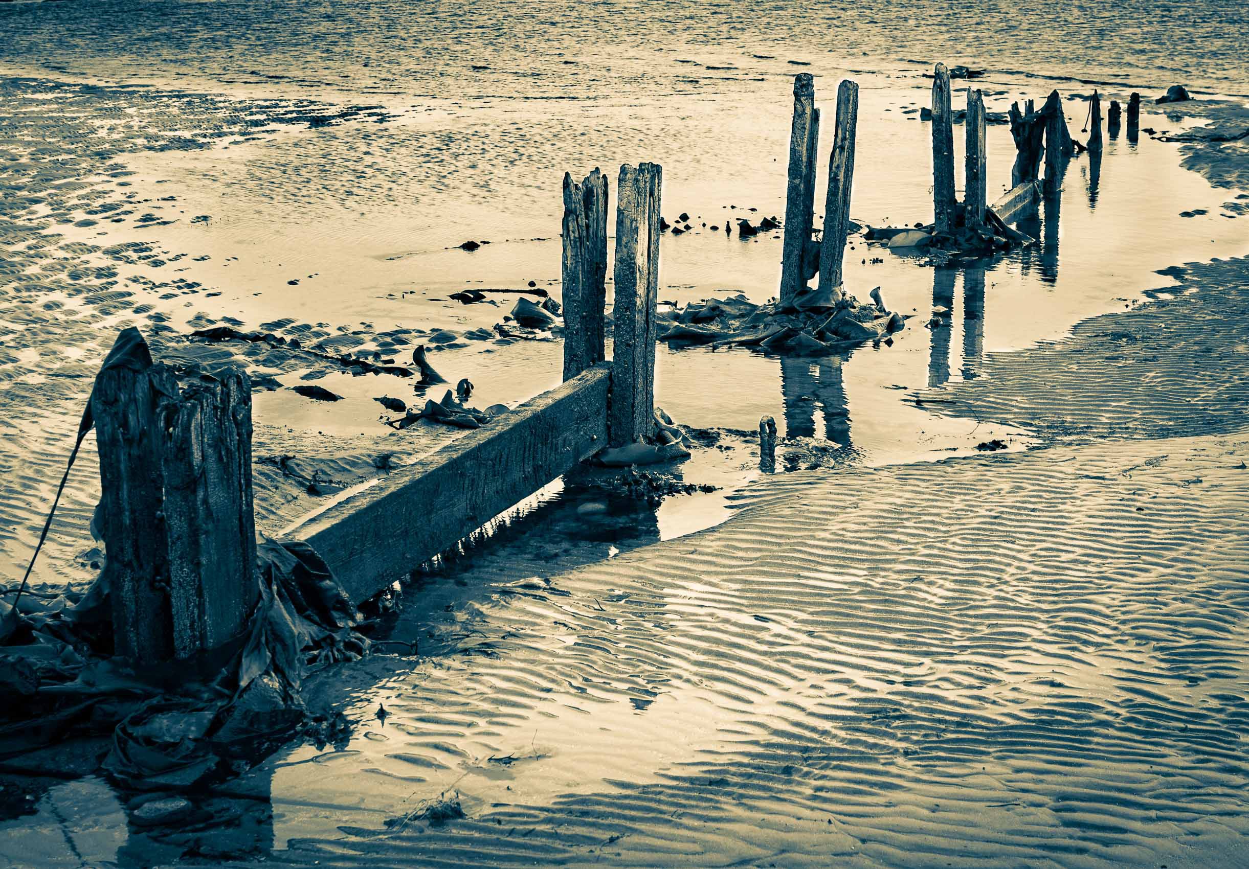 Duotone image of rotting wooden groyne on Broughty Ferry beach, Dundee, Scotland. DD073
