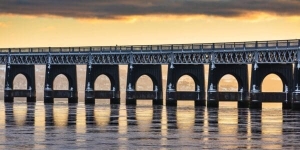 The Tay Railway Bridge backlit by a low winter sun, Dundee, Scotland. DD205