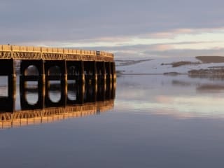 The Tay Railway Bridge lit by a low winter sun, Dundee, Scotland.