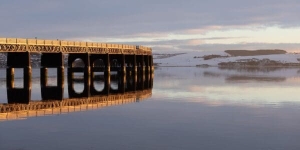 The Tay Railway Bridge lit by a low winter sun, Dundee, Scotland. DD166