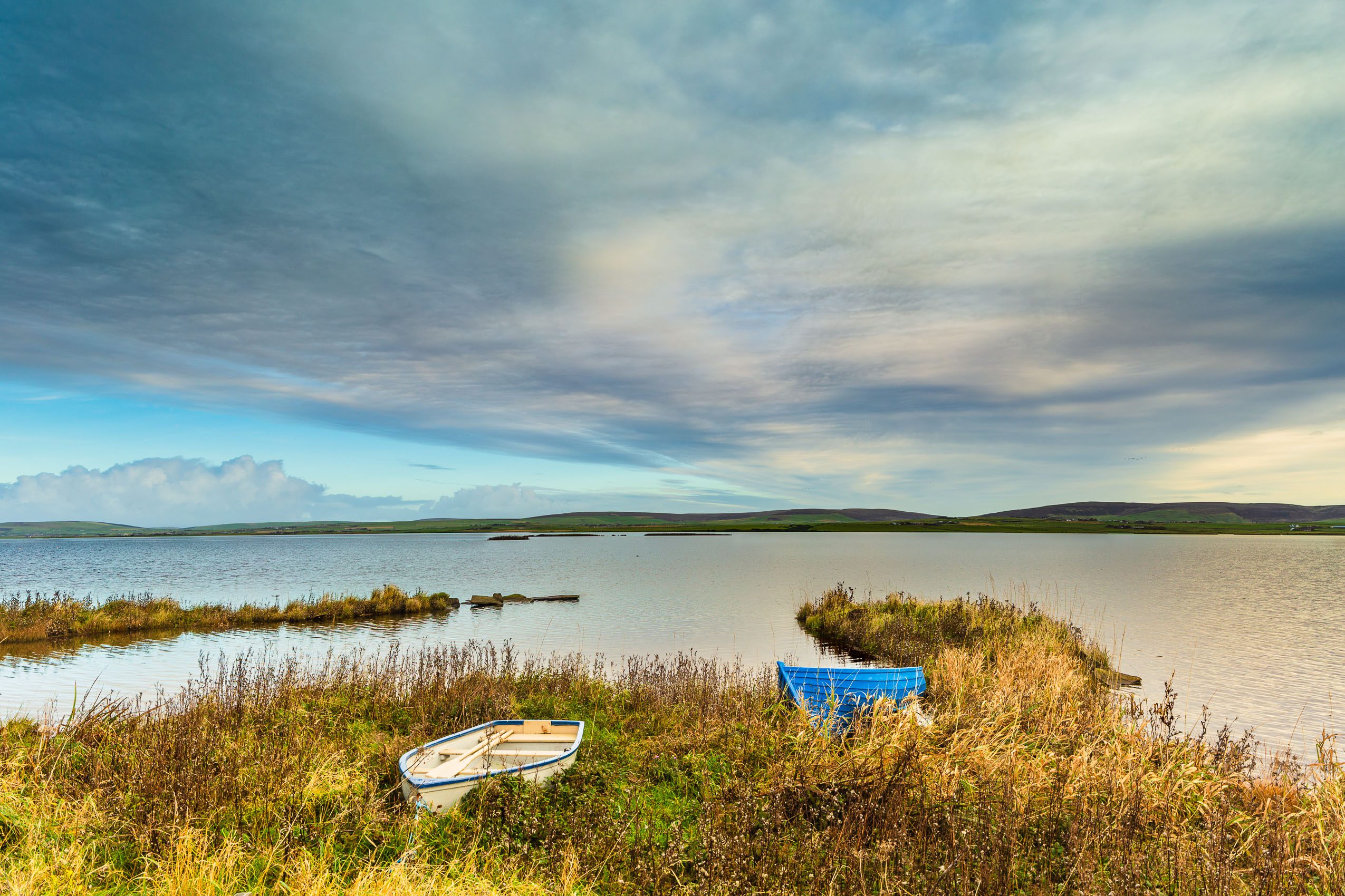 Boats pulled up at the side of the Loch of Harray, Mainland, Orkney Islands. OR003