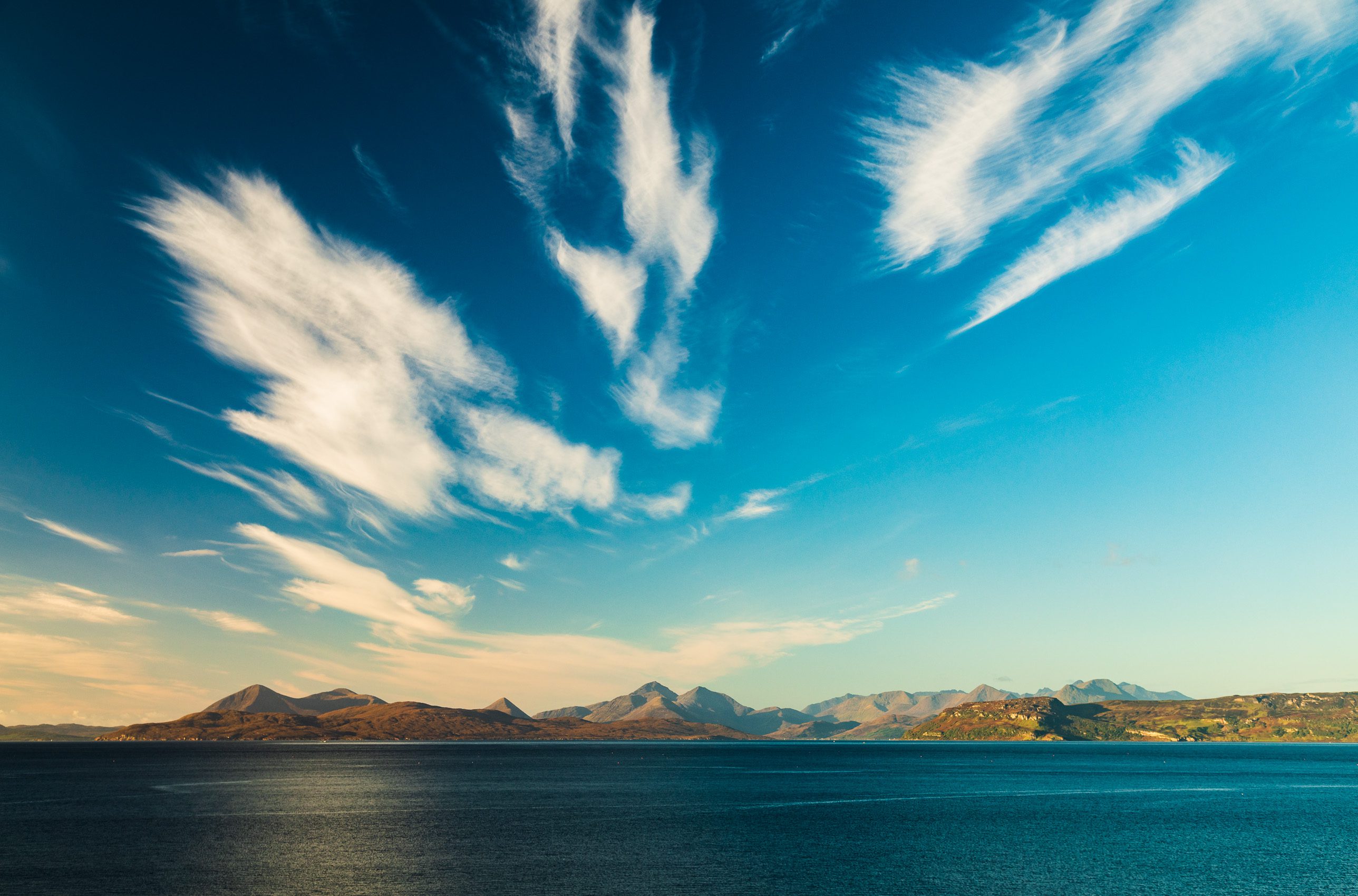 Wind-scattered cloud over Scalpay, Raasay and the Cuillins of Skye from Sand, Applecross, Scotland. AP013