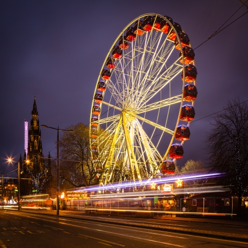Light trails and a a giant Ferris Wheel in Princes Street, Edinburgh, Scotland. EH010