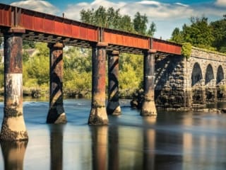 Long exposure image of the disused stone and cast-iron railway bridge over the River Blackwater at Cappoquin, County Waterford, Ireland. BW022