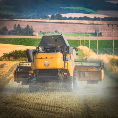 Combine harvester at work in fields near Cupar, Fife, Scotland.
