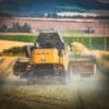 Combine harvester at work in fields near Cupar, Fife, Scotland.