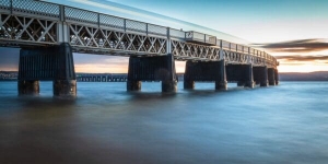 Long exposure as a train passes over the Tay Railway Bridge at high water. DD155
